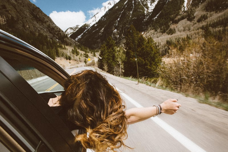 Girl sticks her head out of car window