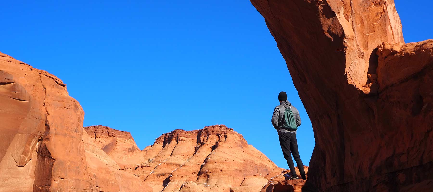 Man standing on red rocks in Utah